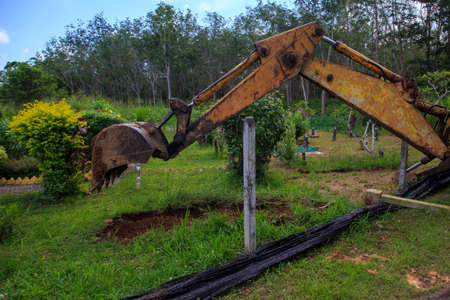 Kedah, Malaysia -May 20, 2021: A man making a grave for funeral at Muslim cemetery.のeditorial素材