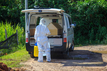 Kuala Lumpur, Malaysia may 2020 - Health workers wearing a PPE suit at graveyard during a funeral for Covid-19 victim in Kuala Lumpur.のeditorial素材