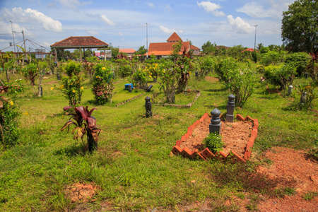 Kedah, Malaysia -May 20, 2021: A man making a grave for funeral at Muslim cemetery.のeditorial素材