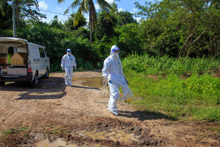 Kuala Lumpur, Malaysia may 2020 - Health workers wearing a PPE suit at graveyard during a funeral for Covid-19 victim in Kuala Lumpur.のeditorial素材