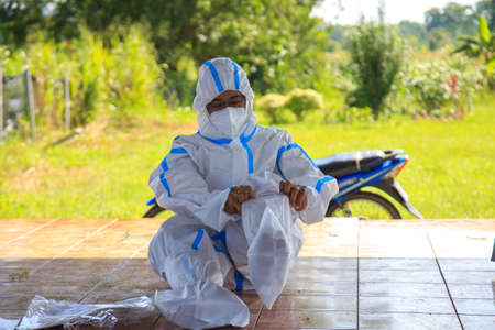 Kuala Lumpur, Malaysia may 2020 - Health workers wearing a PPE suit at graveyard during a funeral for Covid-19 victim in Kuala Lumpur.のeditorial素材