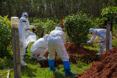 Kuala Lumpur, Malaysia may 2020 - Health workers wearing a PPE suit at graveyard during a funeral for Covid-19 victim in Kuala Lumpur.のeditorial素材