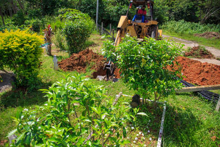 Kedah, Malaysia -May 20, 2021: A man making a grave for funeral at Muslim cemetery.のeditorial素材