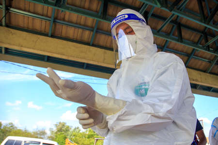 Kuala Lumpur, Malaysia may 2020 - Health workers wearing a PPE suit at graveyard during a funeral for Covid-19 victim in Kuala Lumpur.のeditorial素材