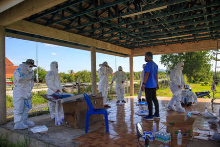Kuala Lumpur, Malaysia may 2020 - Health workers wearing a PPE suit at graveyard during a funeral for Covid-19 victim in Kuala Lumpur.のeditorial素材