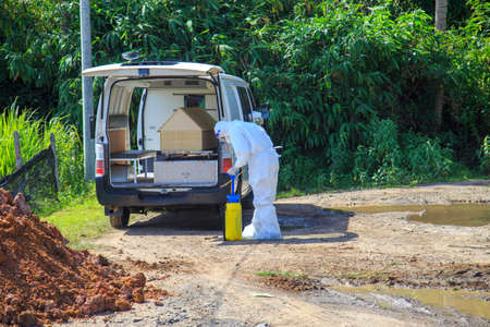 Kuala Lumpur, Malaysia may 2020 - Health workers wearing a PPE suit at graveyard during a funeral for Covid-19 victim in Kuala Lumpur.のeditorial素材