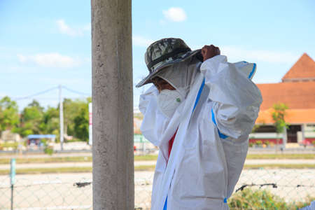 Kuala Lumpur, Malaysia may 2020 - Health workers wearing a PPE suit at graveyard during a funeral for Covid-19 victim in Kuala Lumpur.のeditorial素材