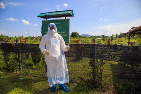 Kuala Lumpur, Malaysia may 2020 - Health workers wearing a PPE suit at graveyard during a funeral for Covid-19 victim in Kuala Lumpur.のeditorial素材