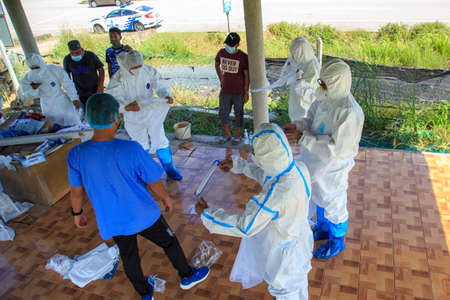 Kuala Lumpur, Malaysia may 2020 - Health workers wearing a PPE suit at graveyard during a funeral for Covid-19 victim in Kuala Lumpur.のeditorial素材