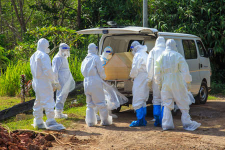 Kuala Lumpur, Malaysia may 2020 - Health workers wearing a PPE suit at graveyard during a funeral for Covid-19 victim in Kuala Lumpur.のeditorial素材