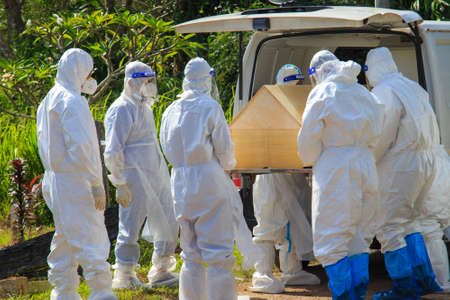 Kuala Lumpur, Malaysia may 2020 - Health workers wearing a PPE suit at graveyard during a funeral for Covid-19 victim in Kuala Lumpur.のeditorial素材