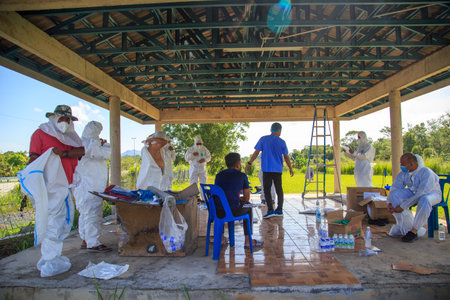Kuala Lumpur, Malaysia may 2020 - Health workers wearing a PPE suit at graveyard during a funeral for Covid-19 victim in Kuala Lumpur.のeditorial素材
