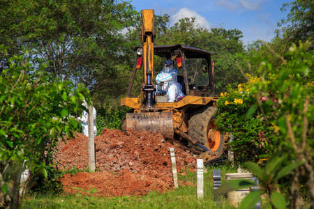 Kuala Lumpur, Malaysia may 2020 - Health workers wearing a PPE suit at graveyard during a funeral for Covid-19 victim in Kuala Lumpur.のeditorial素材