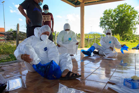 Kuala Lumpur, Malaysia may 2020 - Health workers wearing a PPE suit at graveyard during a funeral for Covid-19 victim in Kuala Lumpur.のeditorial素材