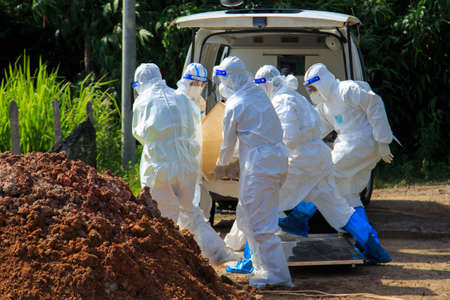 Kuala Lumpur, Malaysia may 2020 - Health workers wearing a PPE suit at graveyard during a funeral for Covid-19 victim in Kuala Lumpur.のeditorial素材