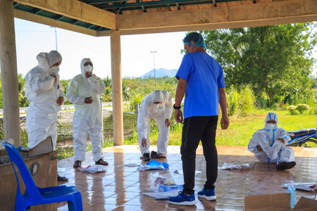 Kuala Lumpur, Malaysia may 2020 - Health workers wearing a PPE suit at graveyard during a funeral for Covid-19 victim in Kuala Lumpur.のeditorial素材