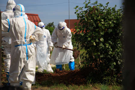 Kuala Lumpur, Malaysia may 2020 - Health workers wearing a PPE suit at graveyard during a funeral for Covid-19 victim in Kuala Lumpur.のeditorial素材