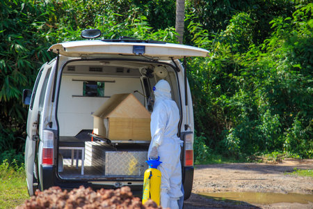 Kuala Lumpur, Malaysia may 2020 - Health workers wearing a PPE suit at graveyard during a funeral for Covid-19 victim in Kuala Lumpur.のeditorial素材