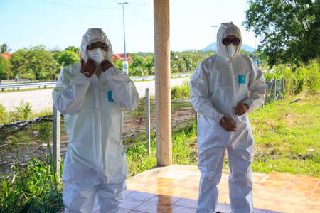 Kuala Lumpur, Malaysia may 2020 - Health workers wearing a PPE suit at graveyard during a funeral for Covid-19 victim in Kuala Lumpur.のeditorial素材