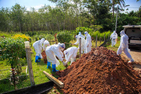 Kuala Lumpur, Malaysia may 2020 - Health workers wearing a PPE suit at graveyard during a funeral for Covid-19 victim in Kuala Lumpur.のeditorial素材