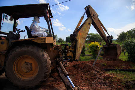 Kuala Lumpur, Malaysia may 2020 - Health workers wearing a PPE suit at graveyard during a funeral for Covid-19 victim in Kuala Lumpur.のeditorial素材
