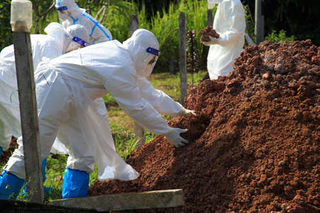 Kuala Lumpur, Malaysia may 2020 - Health workers wearing a PPE suit at graveyard during a funeral for Covid-19 victim in Kuala Lumpur.のeditorial素材