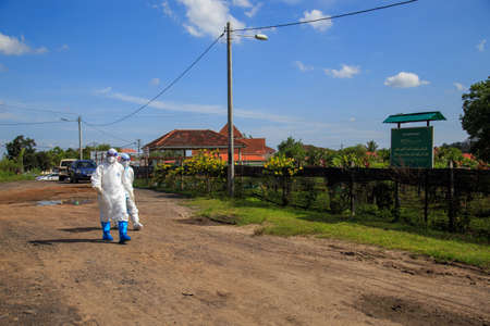 Kuala Lumpur, Malaysia may 2020 - Health workers wearing a PPE suit at graveyard during a funeral for Covid-19 victim in Kuala Lumpur.のeditorial素材