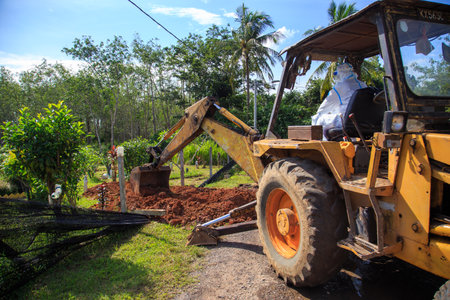 Kuala Lumpur, Malaysia may 2020 - Health workers wearing a PPE suit at graveyard during a funeral for Covid-19 victim in Kuala Lumpur.のeditorial素材
