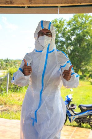 Kuala Lumpur, Malaysia may 2020 - Health workers wearing a PPE suit at graveyard during a funeral for Covid-19 victim in Kuala Lumpur.のeditorial素材