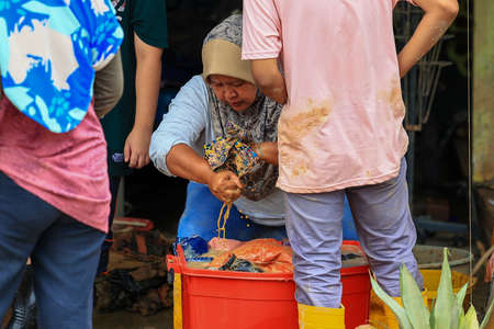 Pahang, Malaysia: January 1, 2022: A group of volunteers help clean the houses of residents affected...