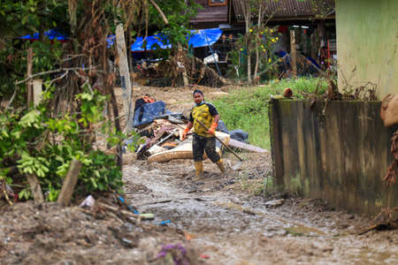 Pahang, Malaysia: January 1, 2022: A group of volunteers help clean the houses of residents affected...