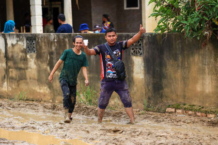 Pahang, Malaysia: January 1, 2022: A group of volunteers help clean the houses of residents affected...