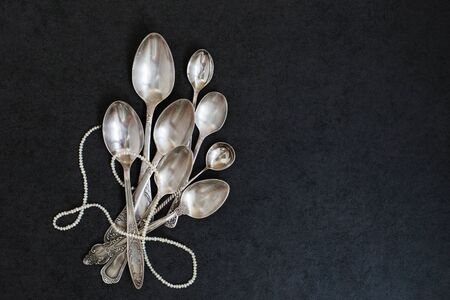 Silver spoons and teaspoons on the grey stone backgroundの写真素材