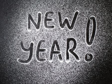 Inscription New Year to sugar on grey stone backgroundの写真素材