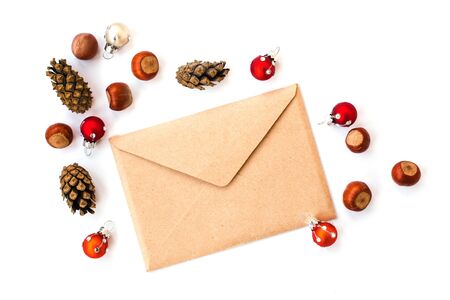 Envelope, cones, hazelnuts  and christmas decorations, isolated in whiteの写真素材
