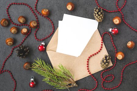 Envelope, cones, hazelnuts  and christmas decorations on grey backgroundの写真素材