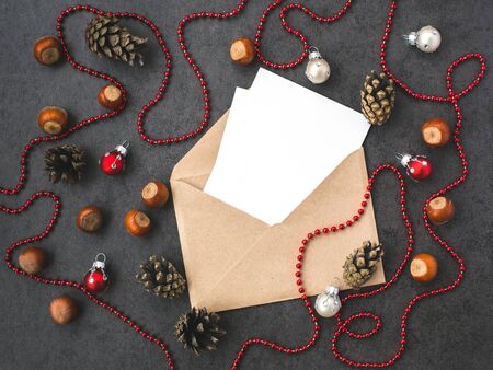 Envelope, cones, hazelnuts  and christmas decorations on grey backgroundの写真素材