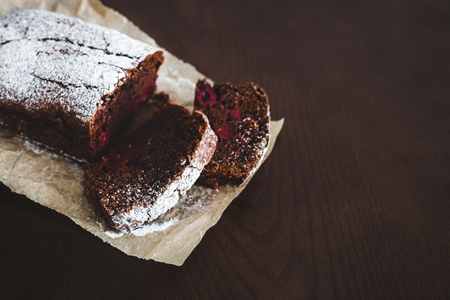 Chocolate cake on baking paper on wooden tableの写真素材