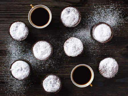 Chocolate cupcake with two cups on wooden backgroundの写真素材