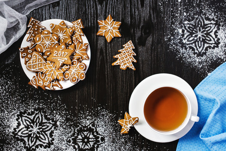 Christmas gingerbread and cup of tea with snowflakes decorationsの写真素材