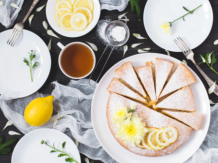 Lemon pie with cup of tea on decorated tableの写真素材