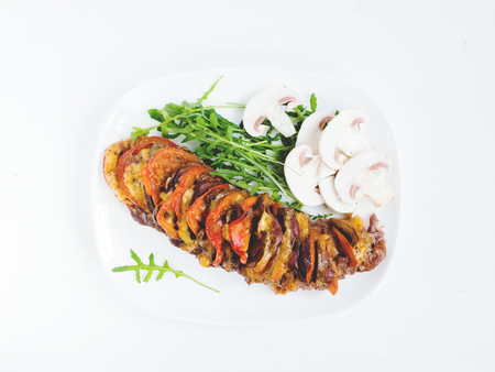 Tasty succulent beef with arugula and mushrooms on white plateの写真素材