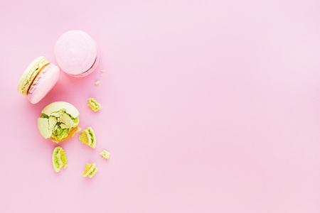 Three homemade macarons on pink background. Top viewの写真素材