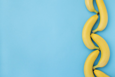 Ornate row of bananas on blue backgroundの写真素材