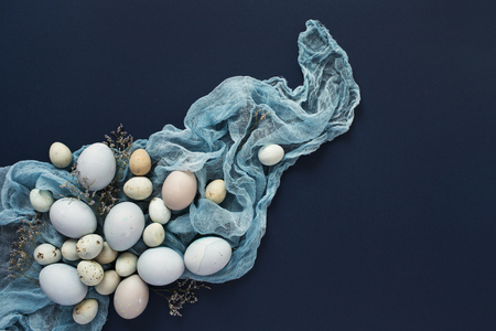 Easter background with blue painted eggs on blue background. Top viewの写真素材