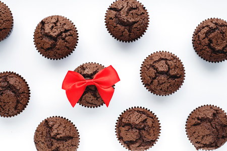 Brownie and red bow on white backgroundの写真素材