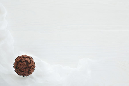 One chocolate maffin on white wooden tableの写真素材