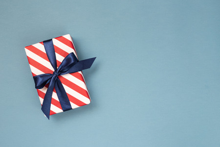 Gift box with blue ribbon.