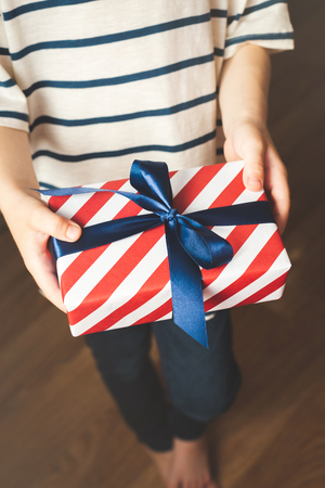 Little boy holding gift box.の写真素材