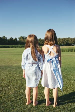 Two girls standing on the field.の写真素材